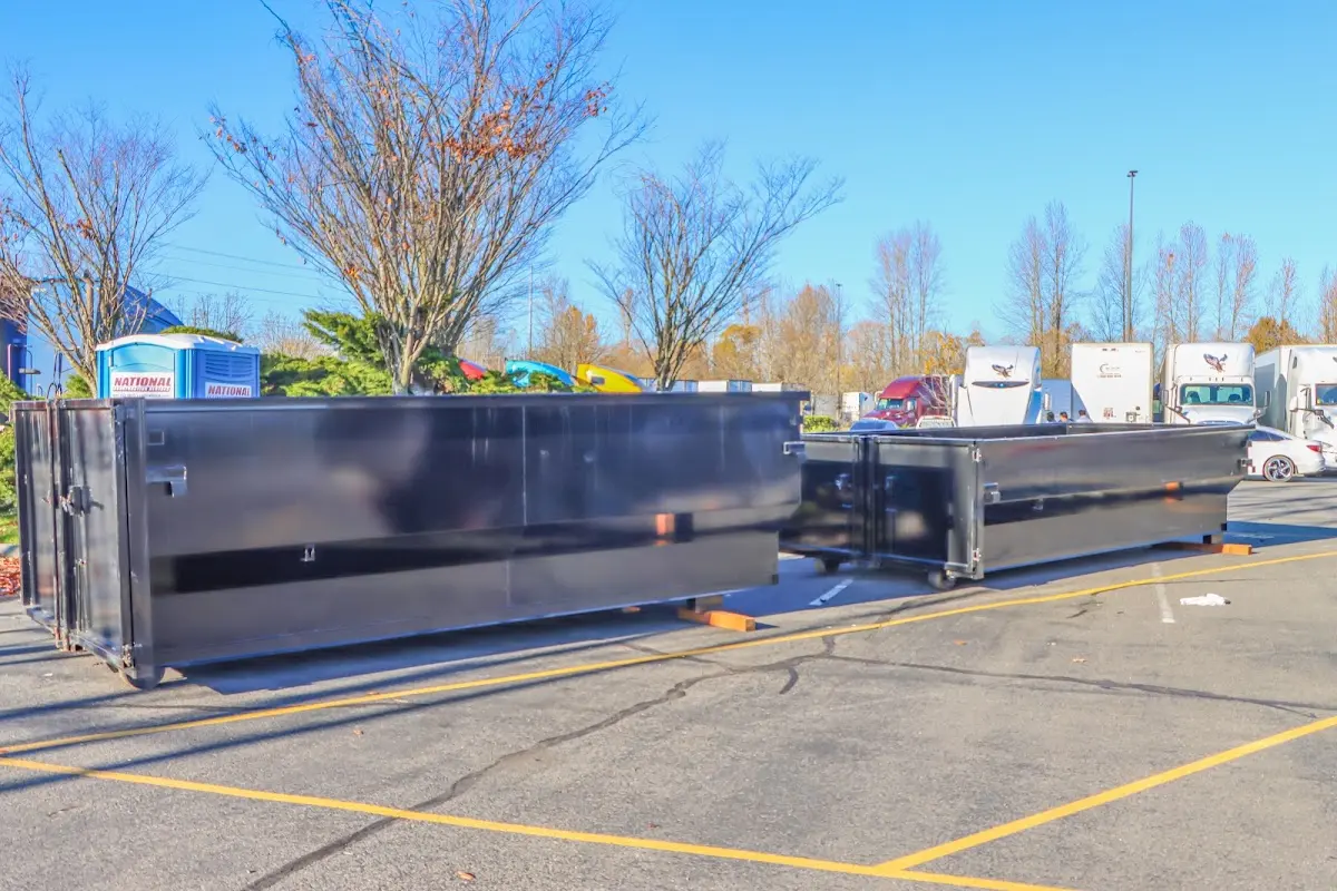 Professional dumpster rental service with roll-off container on residential driveway in Mayfield Heights